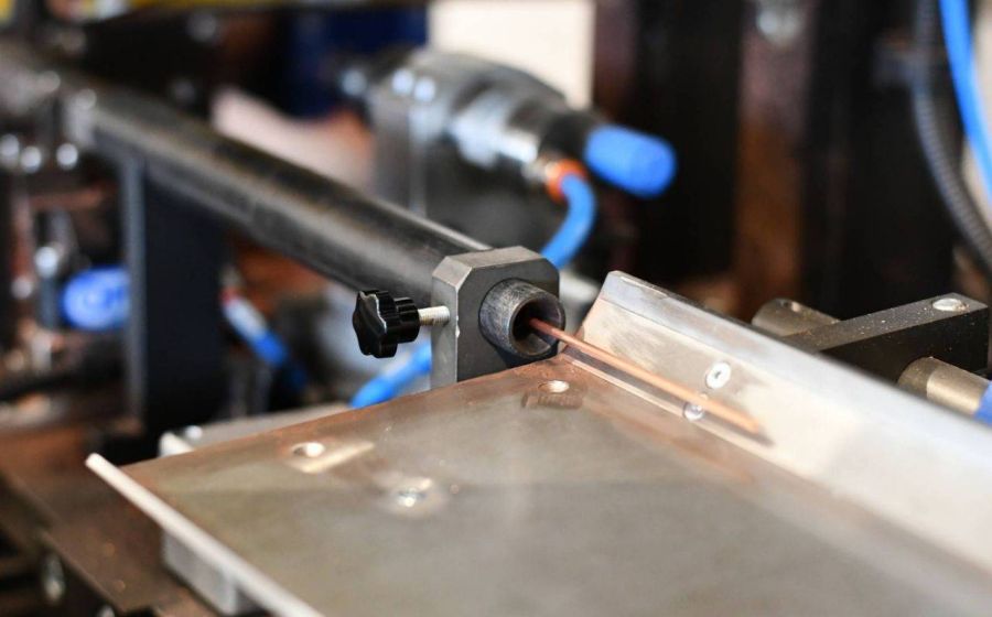 Copper tube feeding system on CNC machine for high-precision tube processing.