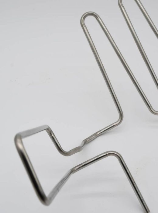 Custom bent stainless steel tubes with complex geometry, manufactured for HVAC and industrial system components.