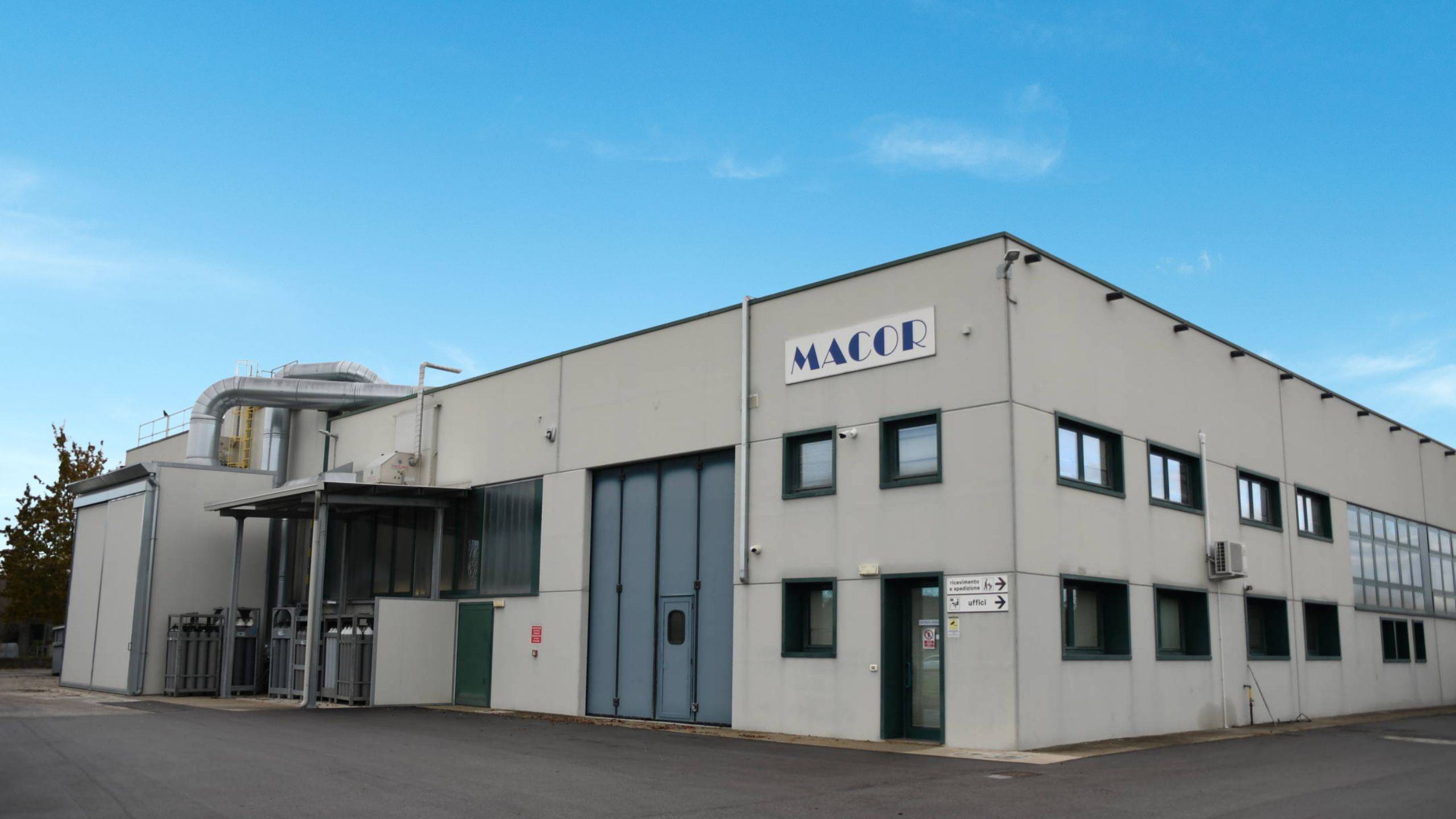 Exterior view of the Macor S.R.L. manufacturing facility in Rivignano Teor, Italy, specialized in copper components, heat exchangers, and HVAC metal processing.
