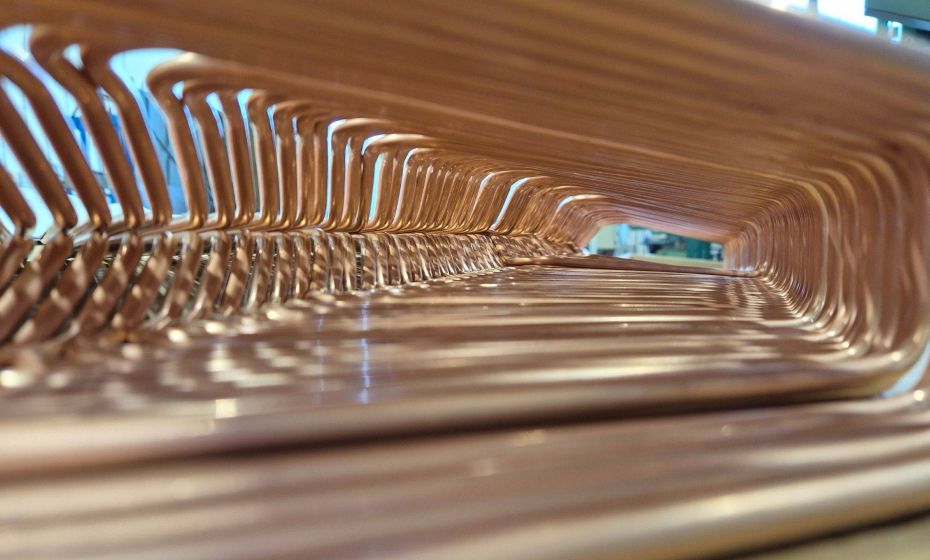 Interior view of a precision-bent copper heat exchanger, highlighting uniform tube spacing and high-accuracy bending for HVAC and refrigeration applications.